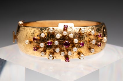 HAMILTON 14K GOLD PEARL AND RUBY CUFF WATCH.