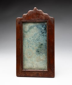 EARLY FRAGMENT MIRROR CARVED FROM A SINGLE PIECE OF WOOD.