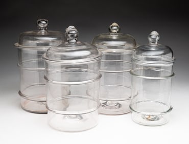 FOUR BLOWN GLASS CANISTER JARS.