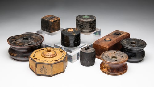 NINE DECORATED WOODEN INKWELLS.