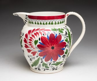LARGE STICK SPATTER PITCHER WITH BOLD AND VIBRANT DECORATION.