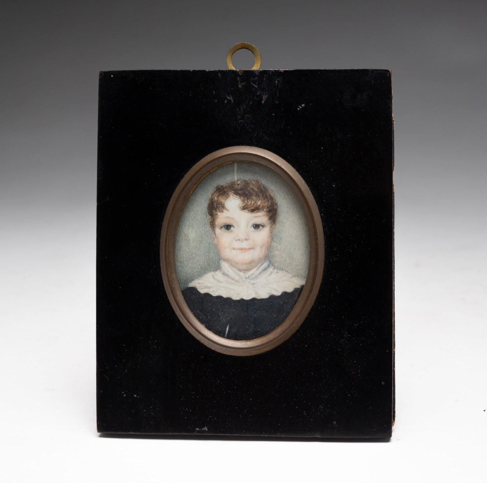 MINIATURE PORTRAIT OF A YOUNG BOY.: American, 19th Century. Oil on natural material. Young boy with dark blonde hair, white high collared shirt with a smile on his face. In painted wood frame with brass liner behind glass, 4.75"h. 4"w. 
