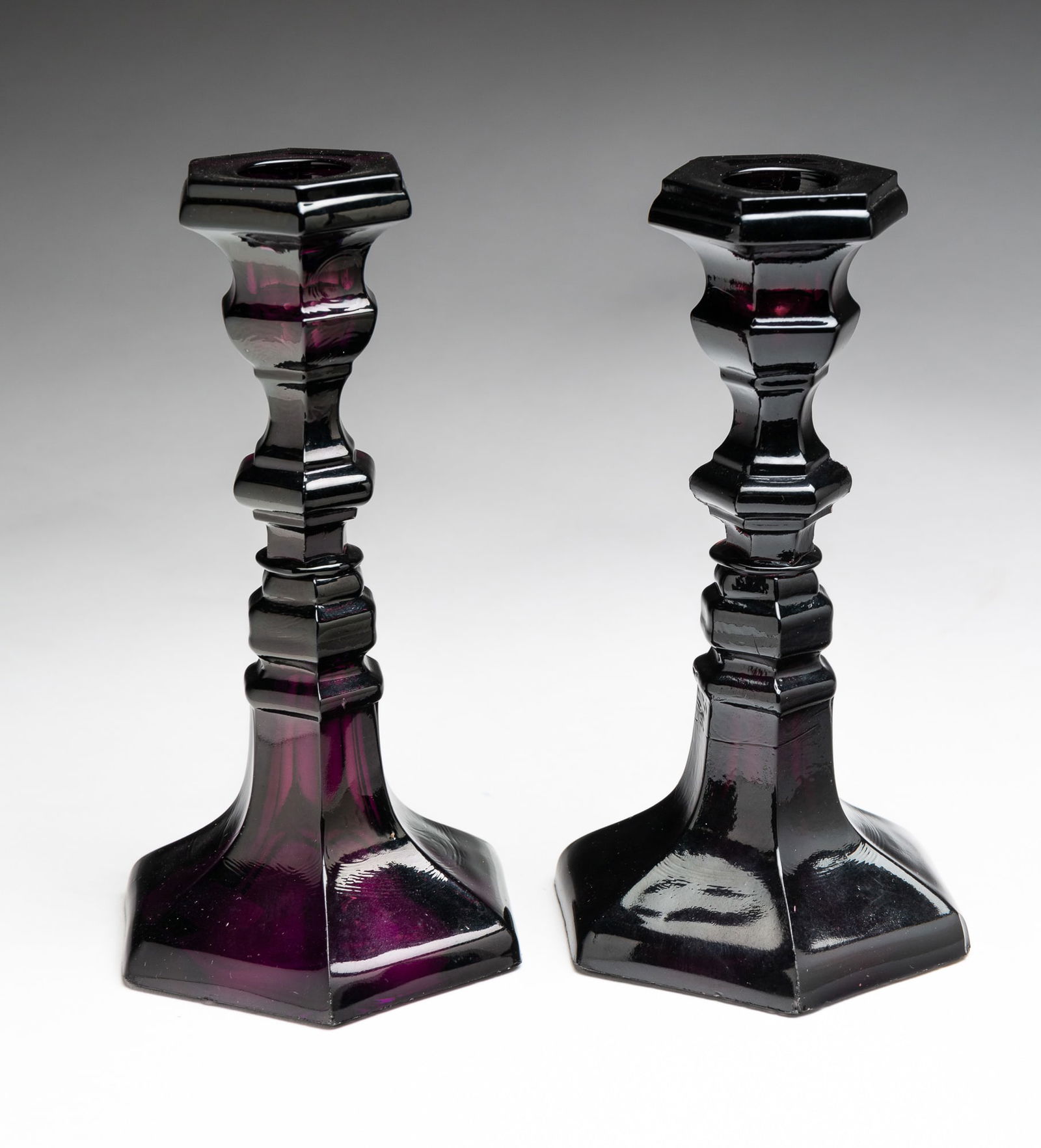PAIR OF SANDWICH GLASS AMETHYST CANDLESTICKS. (1 of 4)