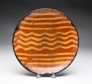 REDWARE PLATE WITH SLIP DECORATION.