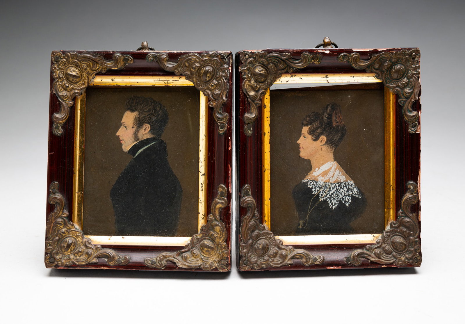 PAIR OF MINIATURE WATERCOLOR PORTRAITS.: American, first half 19th Century. Unsigned. Husband and wife portrayed in black and white formal dress. In wooden frames with brass accents, 5"h. 4"w. From the lifetime collection of the late Audree 