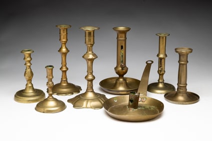 EIGHT BRASS CANDLESTICKS.