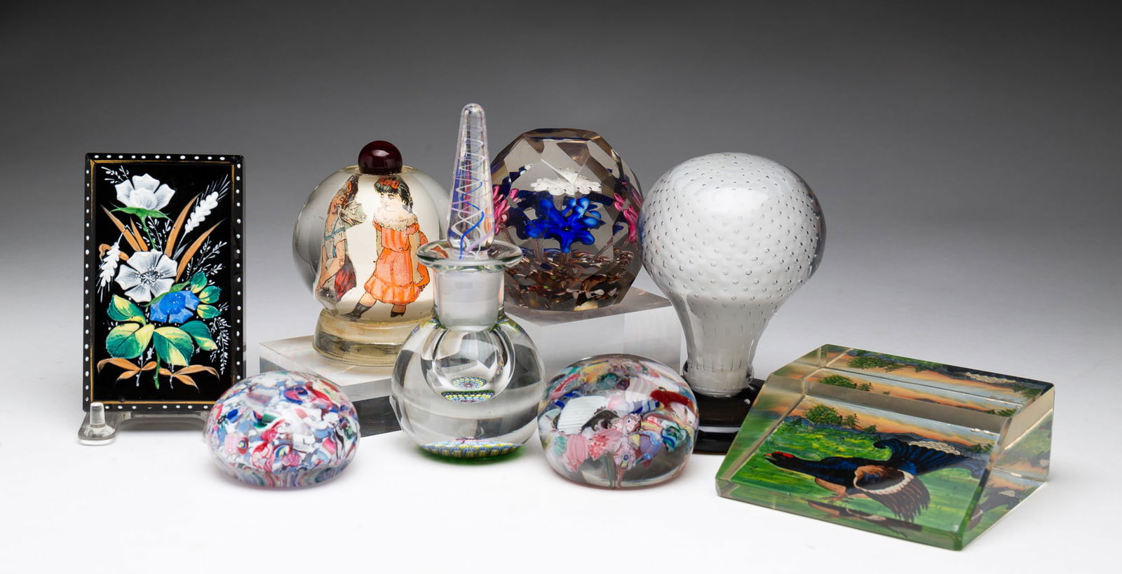 EIGHT PAPERWEIGHTS.: European and American, 19th and 20th Centuries. A Perthshire cologne with swirled stopper and mille fleur bottom, 5.75''h., a pedestal weight, opaque white case in clear, controlled bubbles and smoky