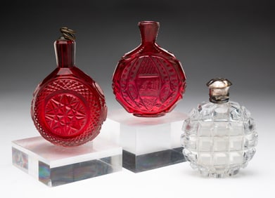 THREE BLOWN AND CUT GLASS FLASKS.