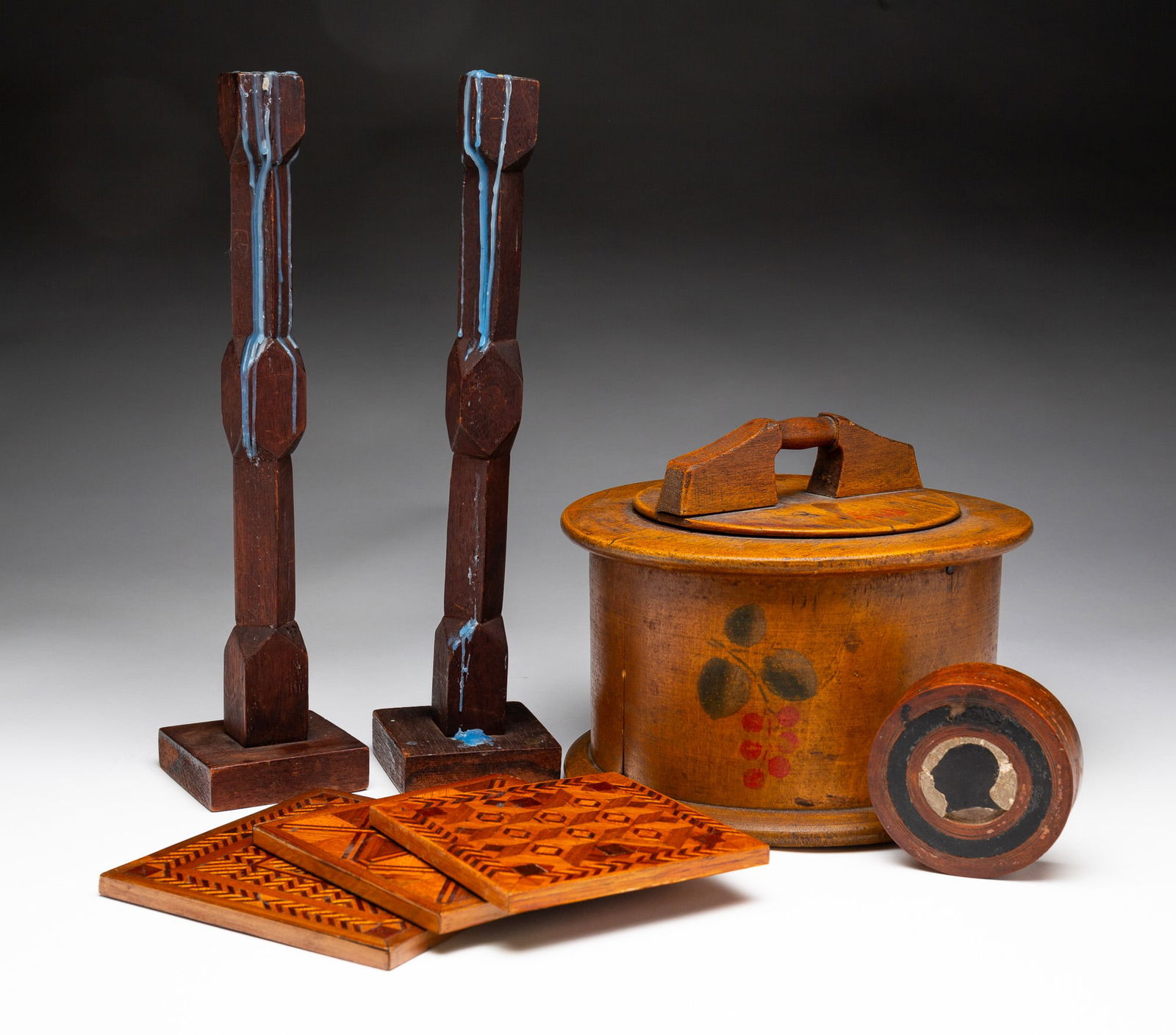 GROUP OF WOODEN HOUSEHOLD ITEMS.: American, early 20th Century. Including a bentwood cake carrier, three brushes, a miniature shaved wood broom, 9.75"h., three square marquetry trivets, a ladle, two scoops, two whimseys, a pair of can
