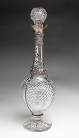 CUT GLASS DECANTER WITH STERLING SILVER MOUNTS.