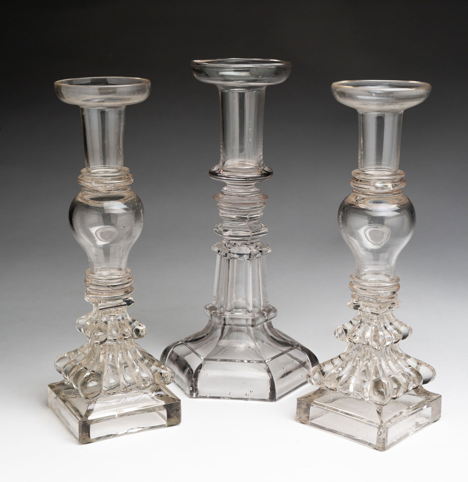 THREE FLINT GLASS CANDLESTICKS. (1 of 4)