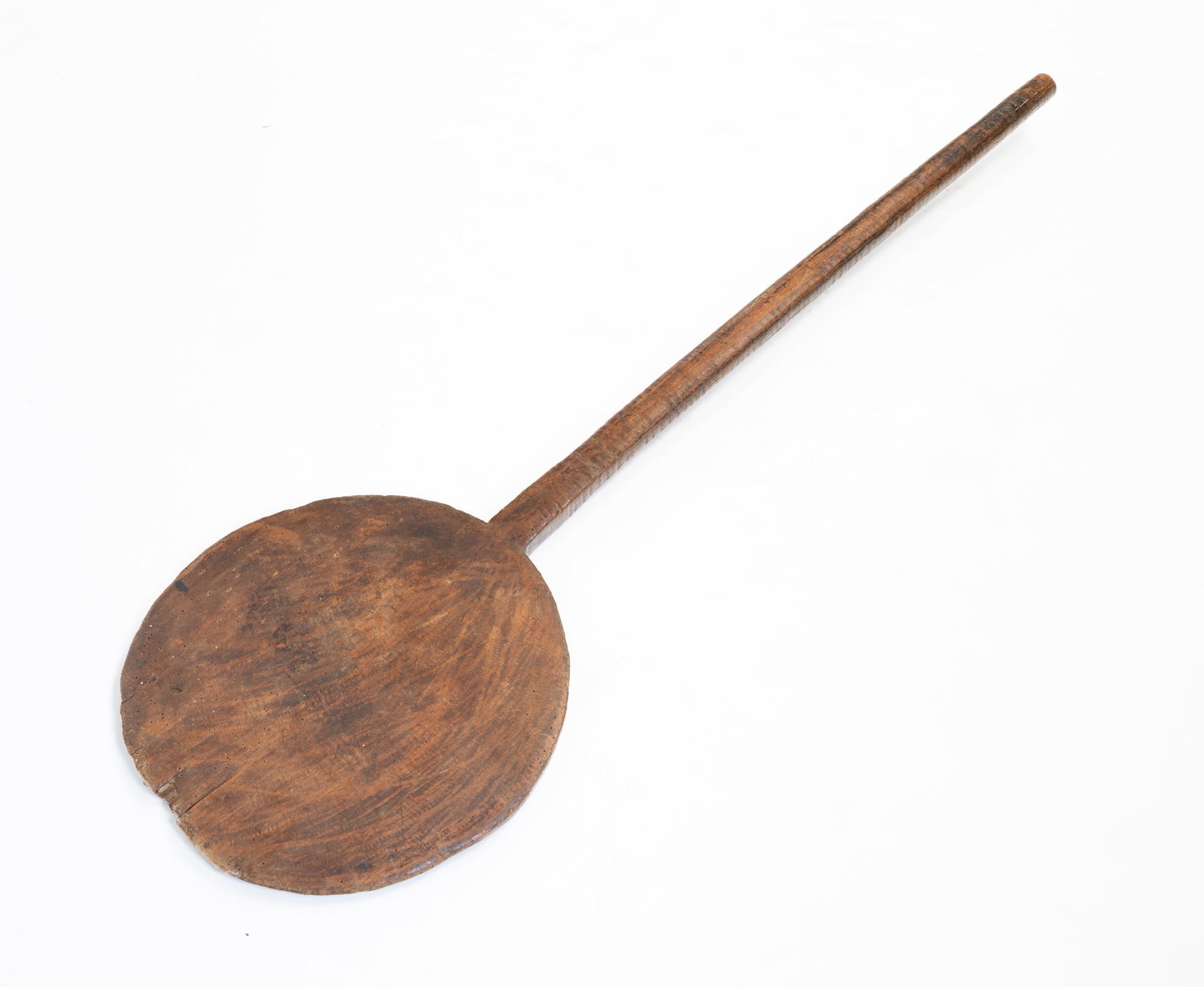 WOOD BAKER'S PEEL.: American, 19th Century. Round peel with blunted end and long carved grip handle. 50.5"h.