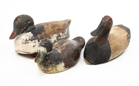 THREE CARVED AND PAINTED DUCK DECOYS.