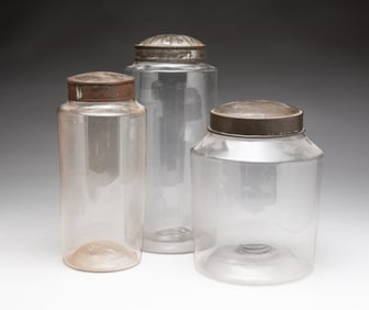 THREE BLOWN FLINT GLASS CANISTERS.
