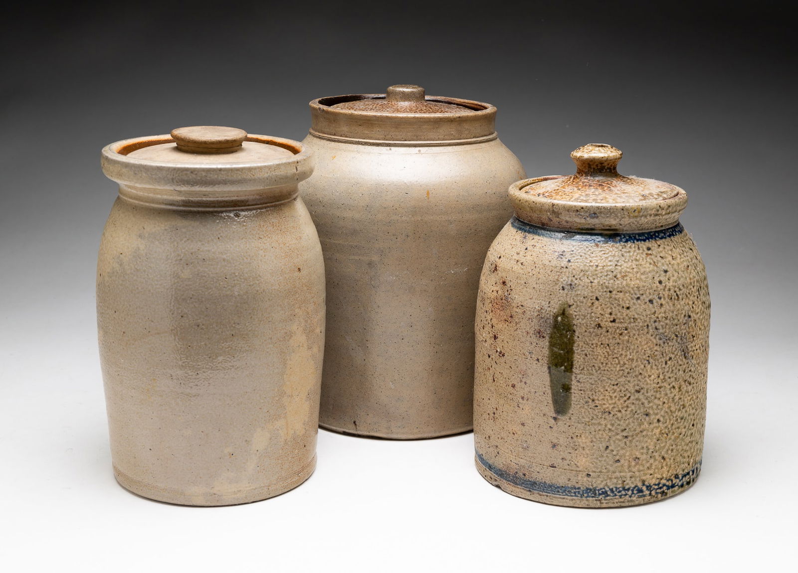 THREE SALT GLAZED STONEWARE LIDDED OVOID JARS. (1 of 5)