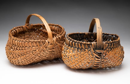 TWO EARLY BUTTOCKS BASKETS.
