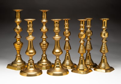 FOUR PAIR OF BRASS CANDLESTICKS