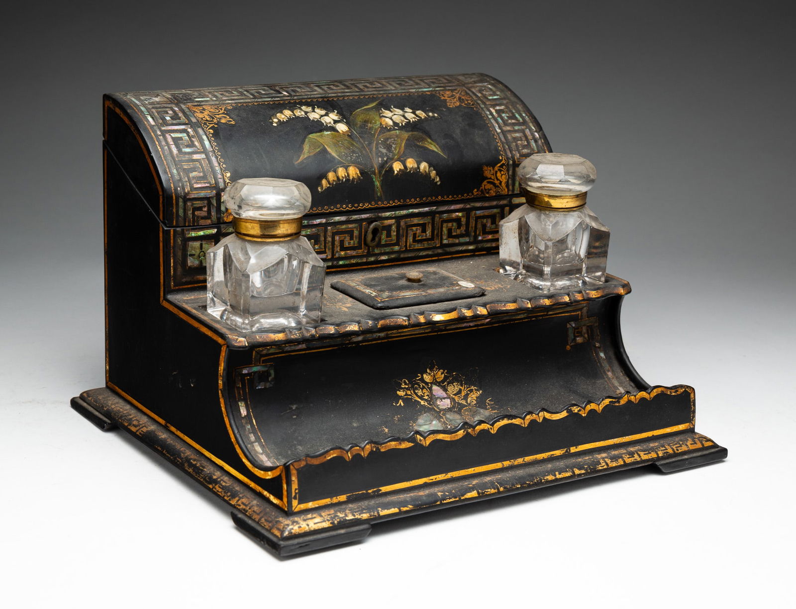 PAPIER MACHE DESK ORGANIZER.: European, 19th Century. Letter file, ink wells with center lidded stamp well, and lower pen dish, nacre Greek key border and gold trim, and lily of the valley painted on lid of letter file. 7.5" h. 11
