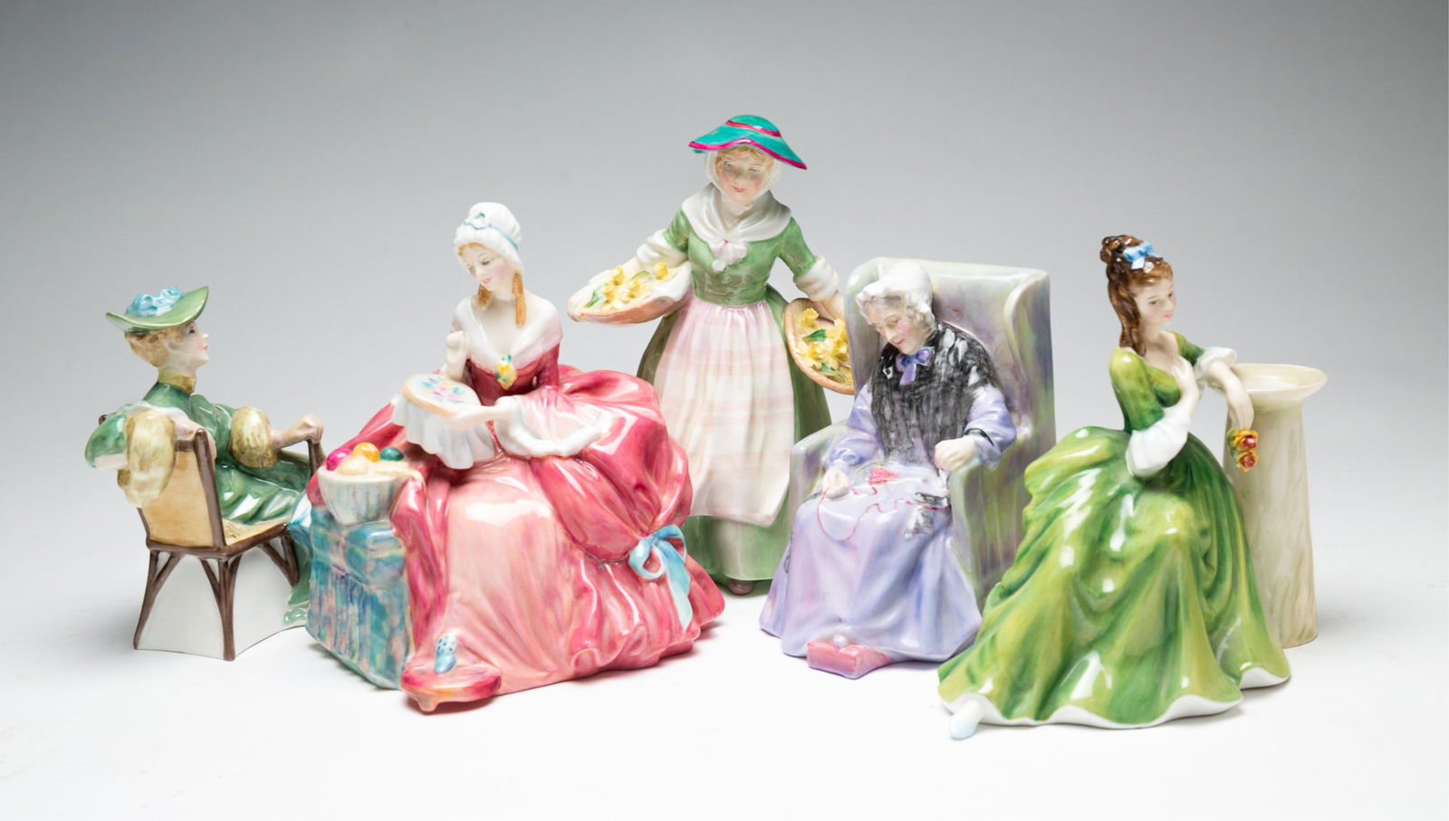 FIVE ROYAL DOULTON FIGURINES OF LADIES.: England, 20th Century. Bone China. Bright colorful glazes: "Joan," 5.5"h., "Daffy Down Dilly" copyright 1935, 8"h., "Penelope" copyright 1939, 7.25" h., "Secret Thoughts" copyright 1970 andreissued fo