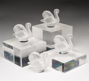 FOUR MINIATURE SIGNED LALIQUE SWANS.