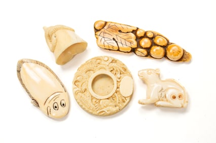 FOUR CARVED NETSUKES AND A MINIATURE PICTURE FRAME.