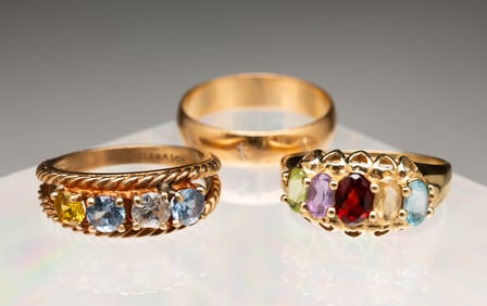 THREE 10K YELLOW GOLD RINGS.
