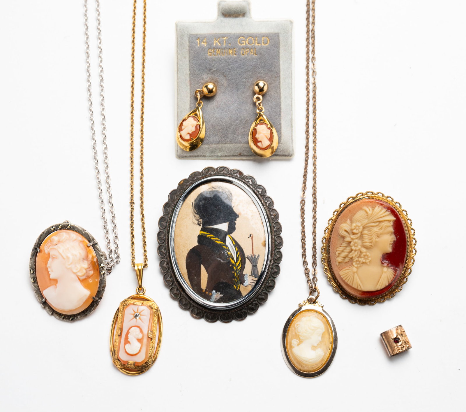 GROUP OF MOSTLY CAMEO JEWELRY.: Seven pieces including: three carved shell cameo necklaces, one with pin back and mounted in 800 silver; one oval cameo brooch; pair of gold filled cameo earrings; vintage brooch with silhouette of a