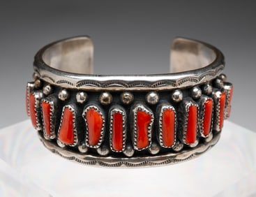 NAVAJO SIGNED CORAL AND SILVER CUFF BRACELET.