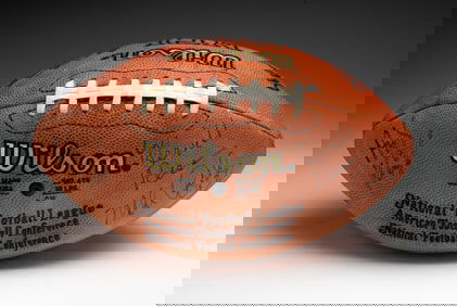 AUTOGRAPHED FOOTBALL BY ANDY REID, MIKE QUICK AND MERRILL REECE.