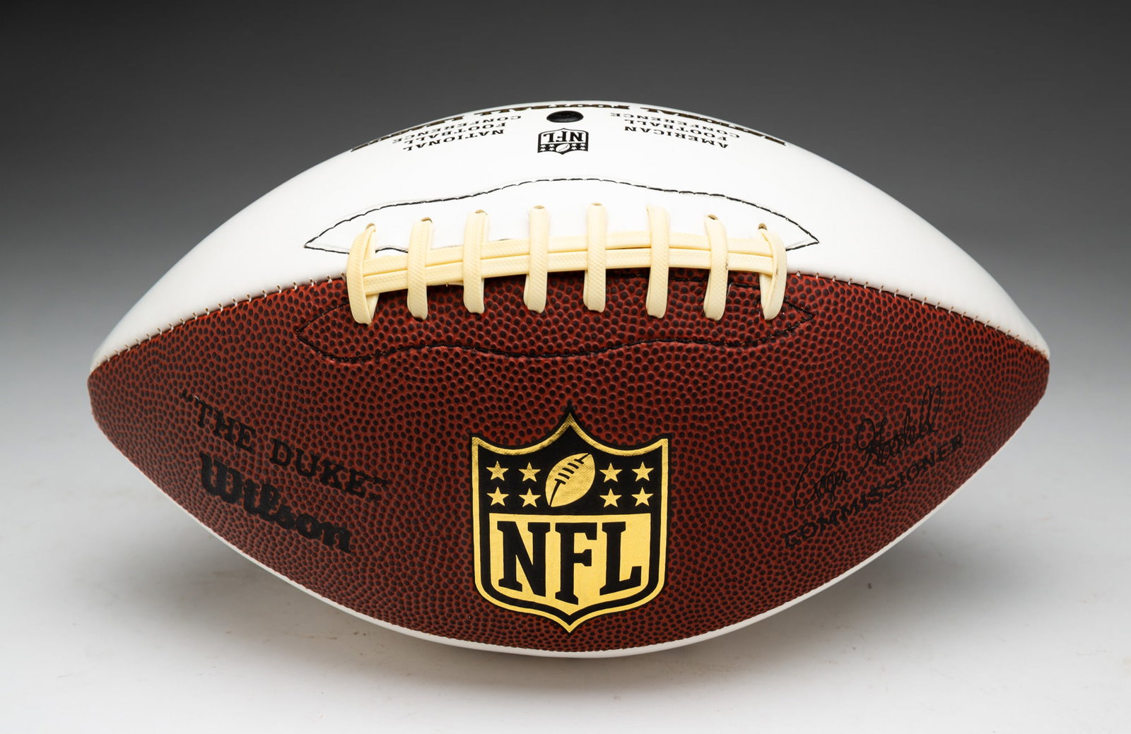 AUTOGRAPHED FOOTBALL BY ARCHIE MANNING.: American, 20th - 21st Century. Two-tone NFL Goodell football signed and inscribed, "To Jon & Susie". Manning played professional football for the New Orleans Saints, Houston Oilers, and the Minnesota 