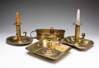GROUP OF FOUR BRASS CHAMBERSTICKS.