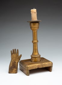 PAINTED WOODEN CANDLESTICK AND HAND.