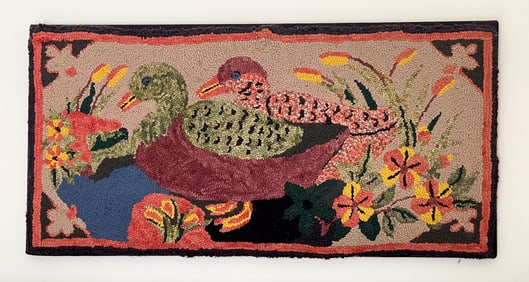 BOLDLY COLORED HOOKED RUG WITH TWO DUCKS.
