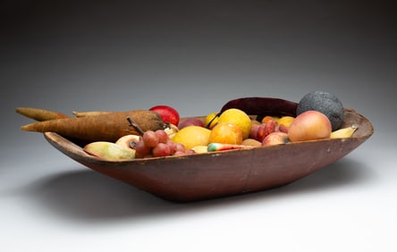 WOODEN TRENCHER FILLED WITH FRUITS.