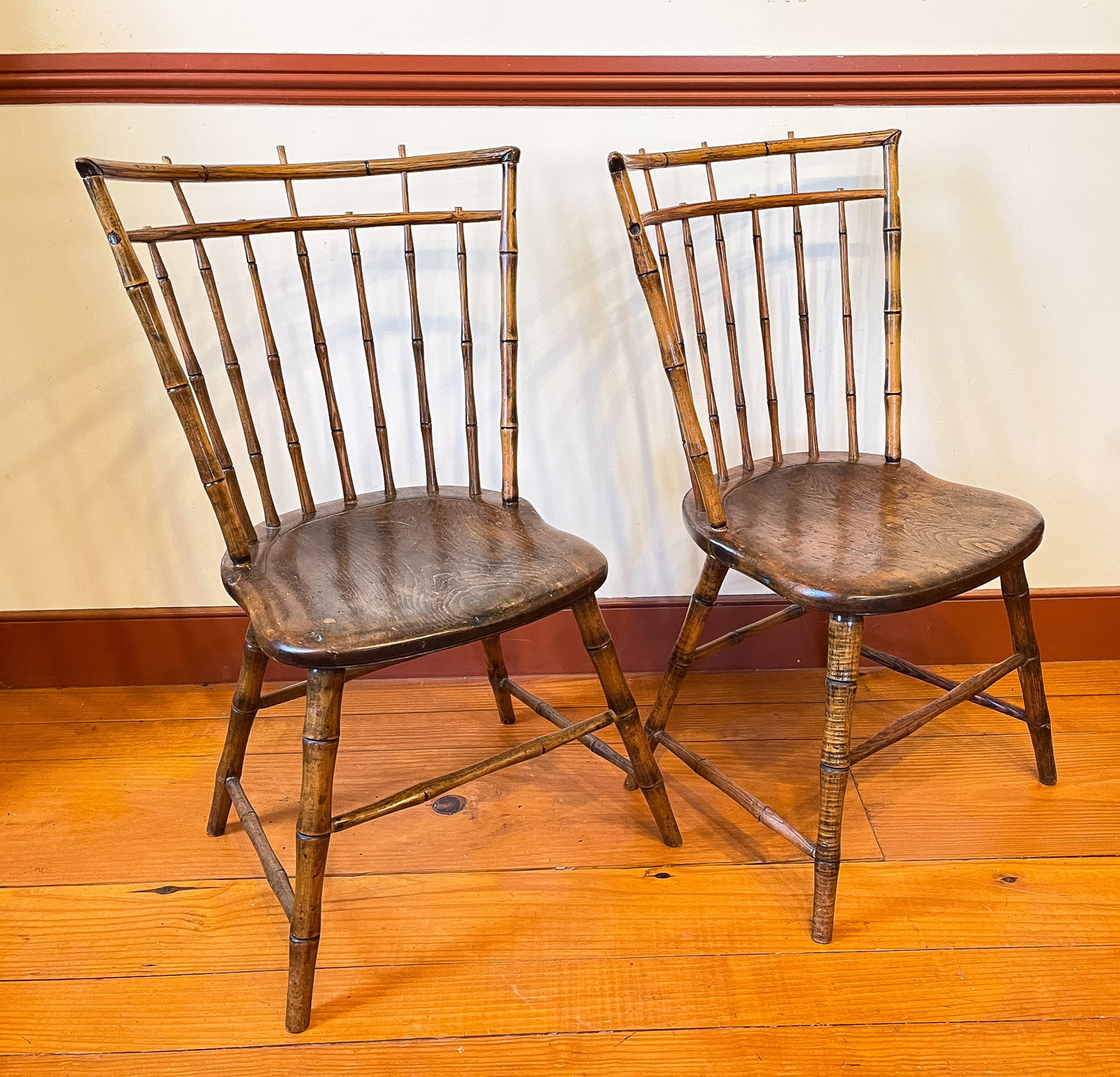 A PAIR OF BIRDCAGE BAMBOO WINDSOR SIDE CHAIRS.: American, circa 1800. Mixed woods. Bold bamboo turnings and plank seats. 16.5" seat ht. Overall, 33"h.