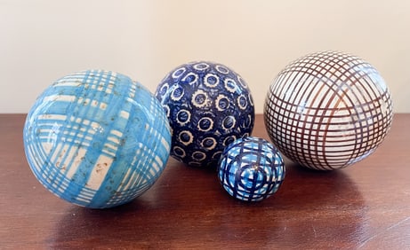 FOUR CARPET BALLS.