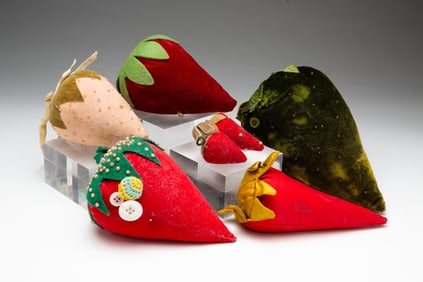 SEVEN STRAWBERRY PINCUSHIONS.