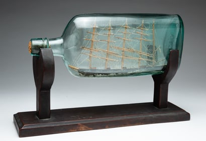 FOLK ART FIVE MASTED SHIP IN A BOTTLE ON STAND.