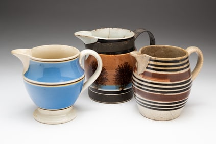 TWO DIMINUTIVE MOCHAWARE DECORATED PITCHERS AND A CREAM PITCHER.