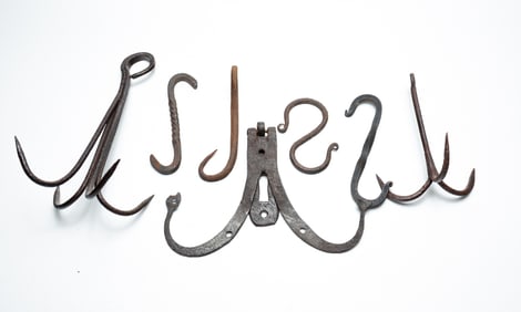 GROUP OF FORGED IRON HOOKS AND HANGERS.
