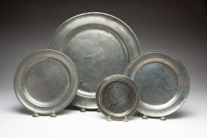 FOUR PEWTER PLATES.