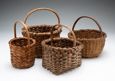 FOUR DIMINUTIVE HANDLED BASKETS.