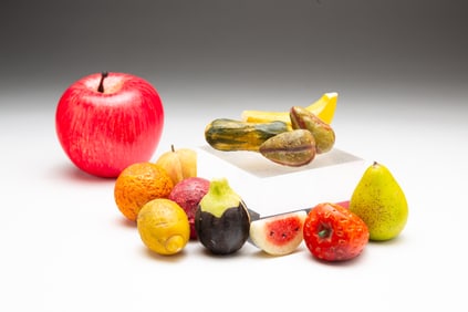 GROUP OF MINIATURE STONE FRUIT AND VEGETABLES.