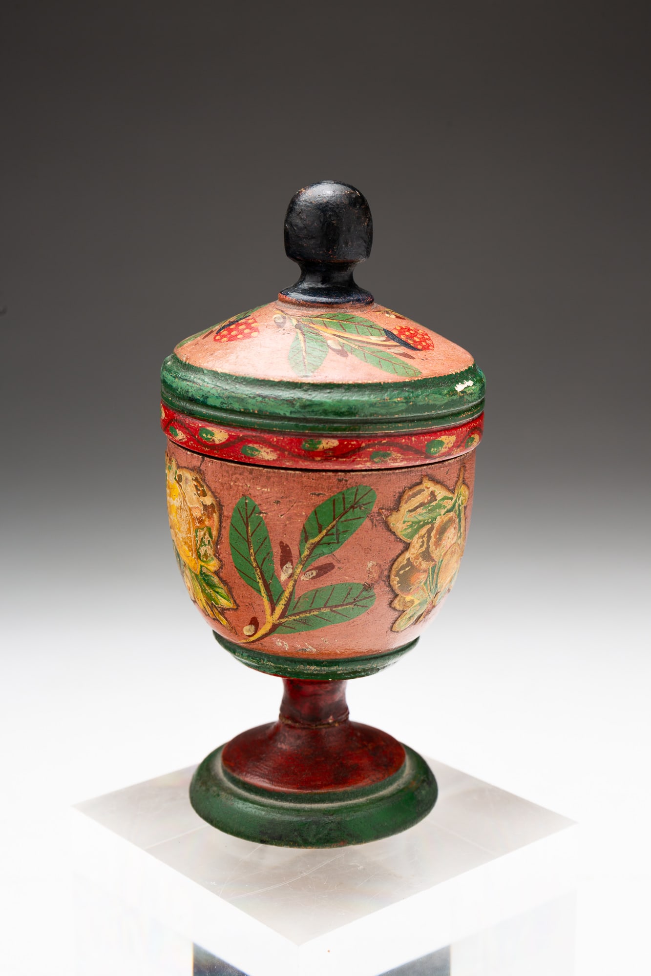 COVERED LEHNWARE FOOTED SAFFRON CUP.: American (Lancaster County, Pennsylvania), 19th Century. Turned wood. Polychrome decoration with fruits, berries and leaves. 5.25"h. 2.5"w.