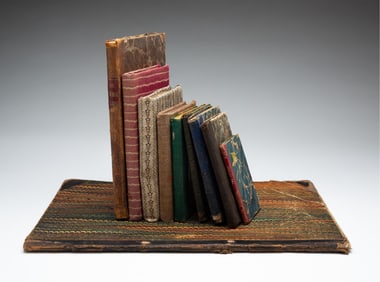 TEN BOOKS WITH MARBLED AND SEWN CLOTH COVERS.