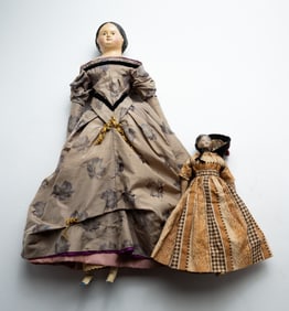 TWO PAPIER-MACHE AND WOOD DOLLS.