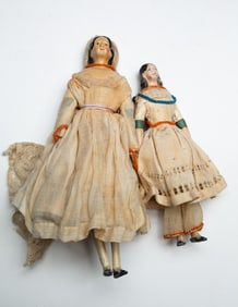 TWO PAINTED WOOD, PAPIER-MACHE, AND CLOTH DOLLS.
