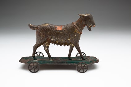 PRESSED TIN AND PAINTED GOAT PULL TOY.