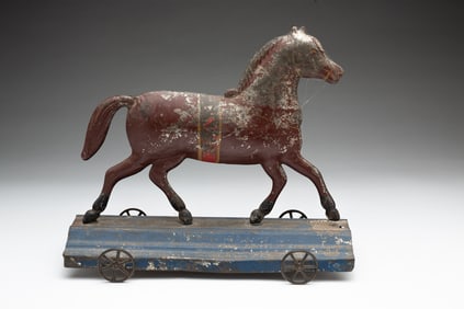 PRESSED TIN AND PAINTED HORSE PULL TOY.