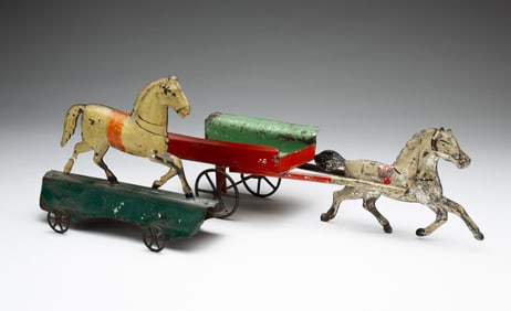 TWO PRESSED AND PAINTED TIN HORSE PULL TOYS.